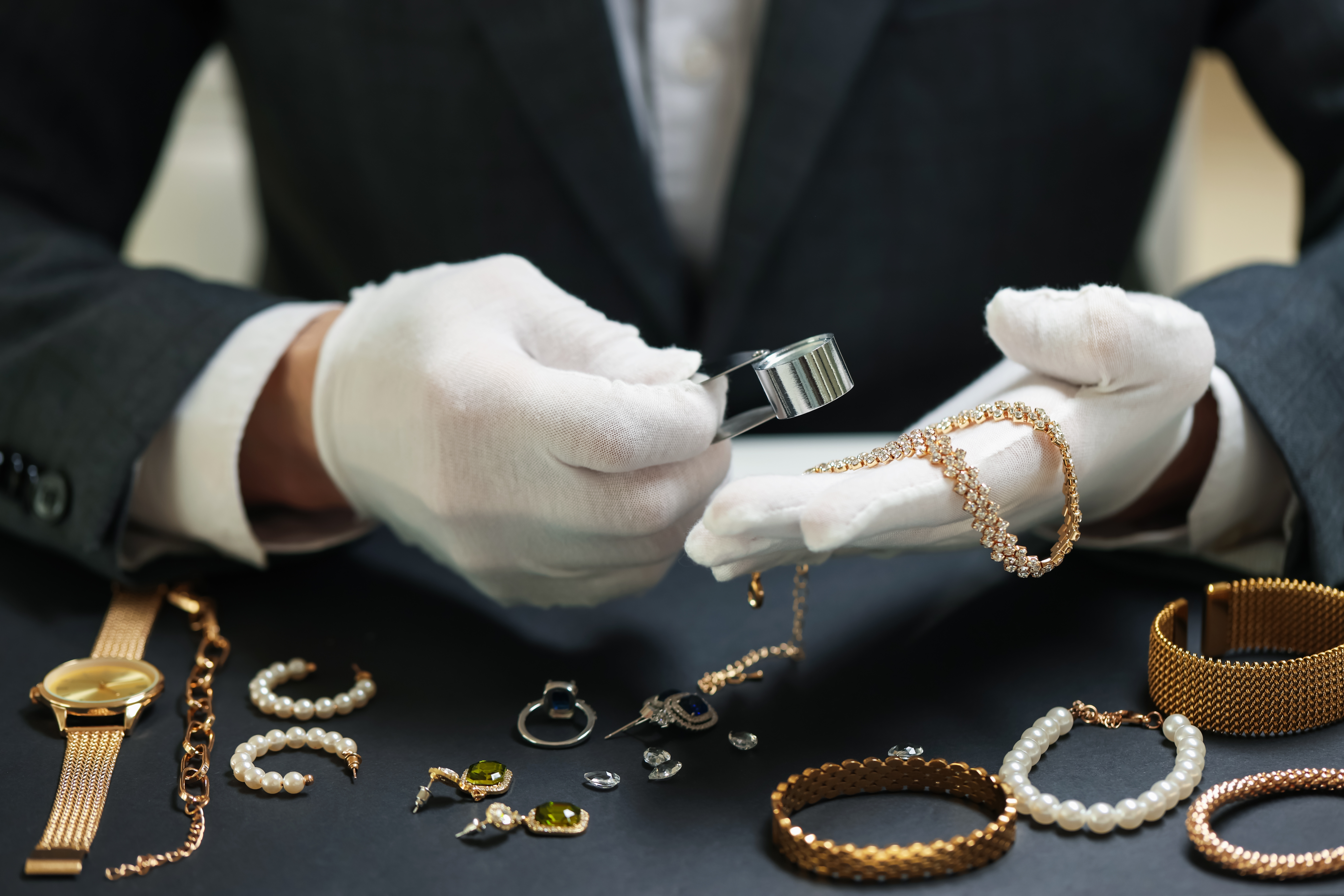 A buyer at one of our events inspecting customer jewellery under loupe